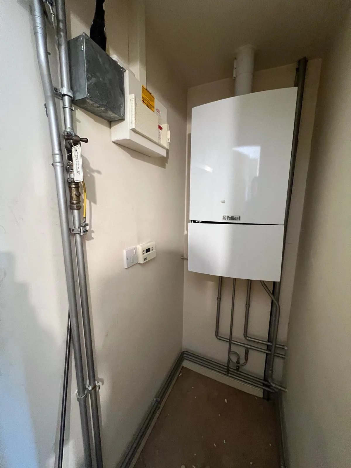 Older Vaillant boiler with dated pipework and header tank before replacement