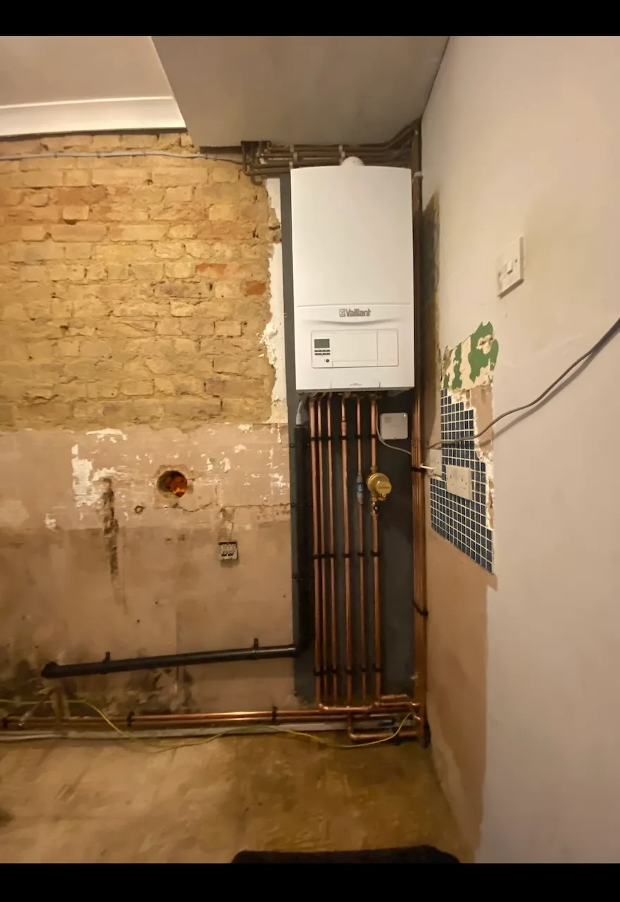 Bare brick room with wall plate and flue hole ready for boiler