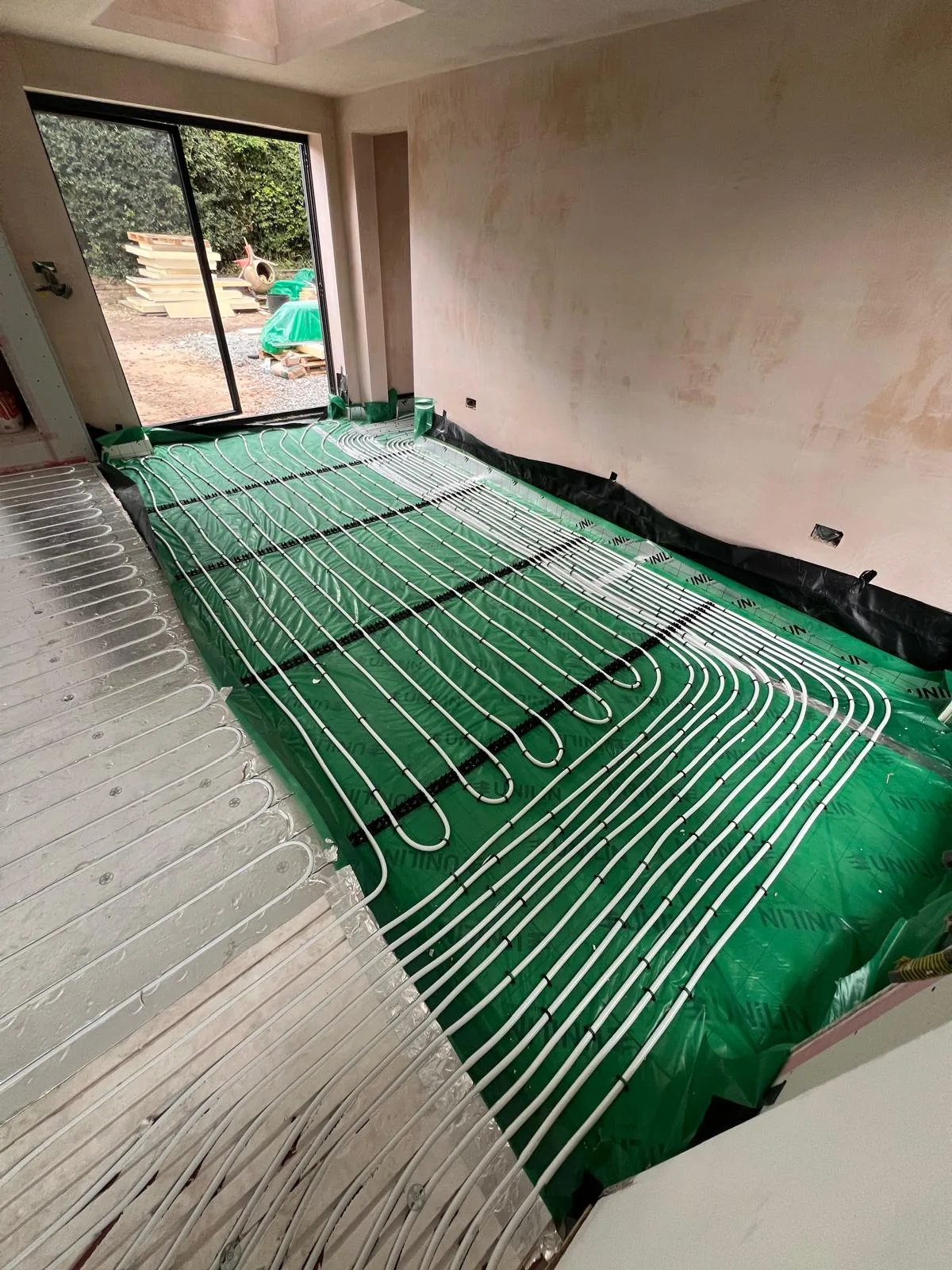 Underfloor heating pipework clipped and pressure-tested