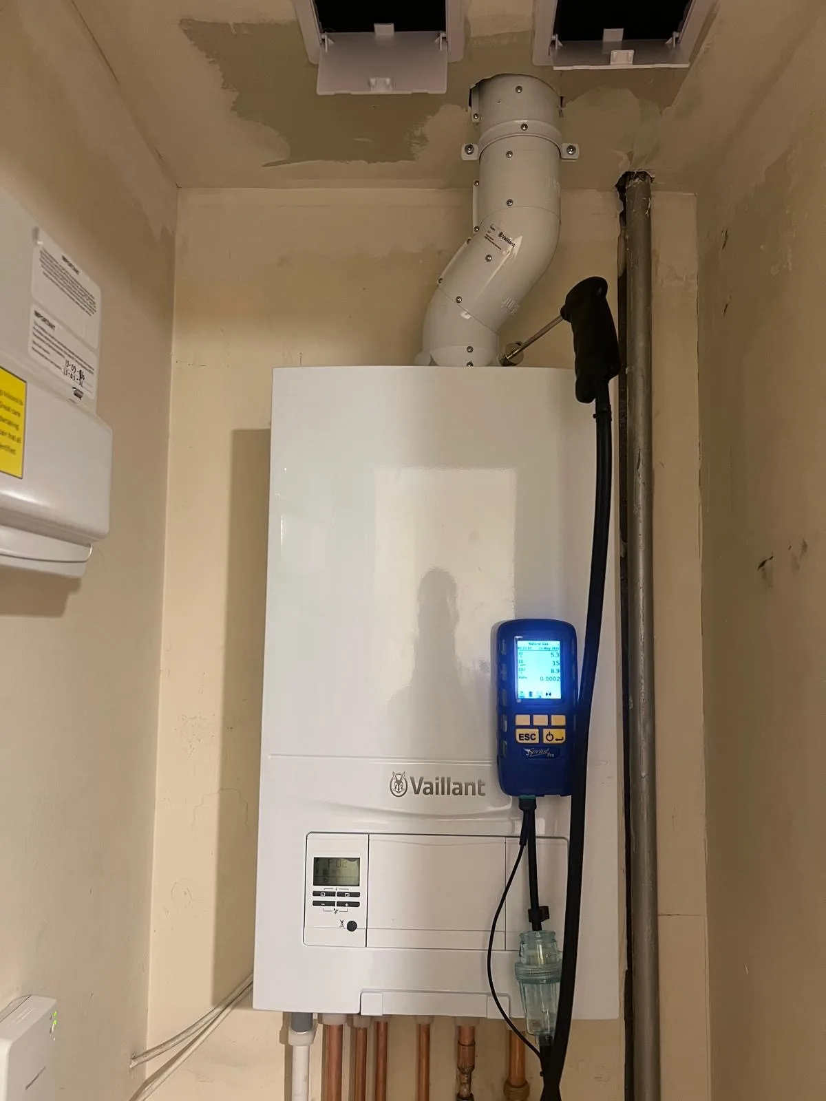 Vaillant boiler being commissioned with a flue gas analyser to check combustion